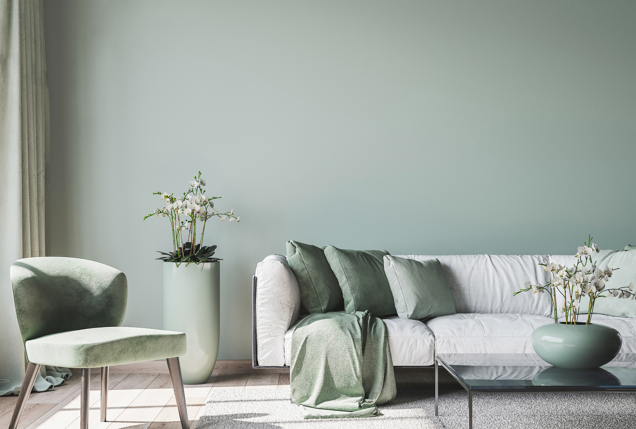 light teal painted lounge with grey and green accessories
